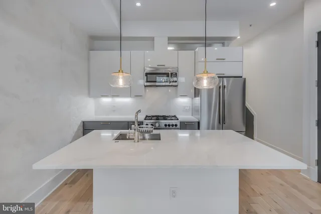 a kitchen with a sink and stainless steel appliances