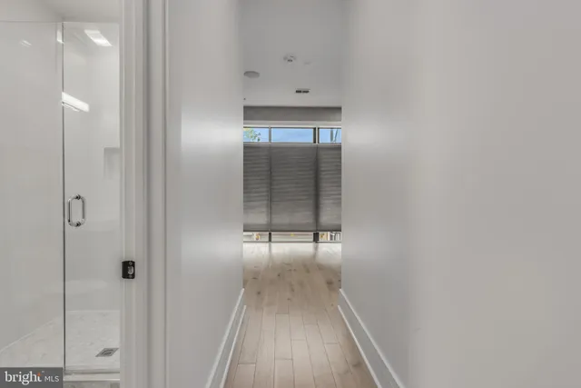 a view of an empty room with wooden floor