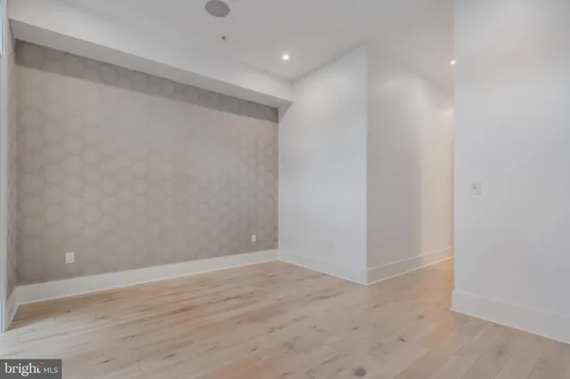 a view of a room with wooden floor and cabinet