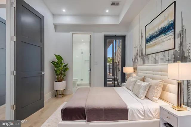 a bedroom with a bed and a potted plant