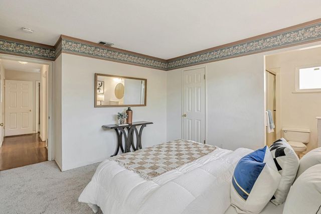 a bedroom with a bed and a table