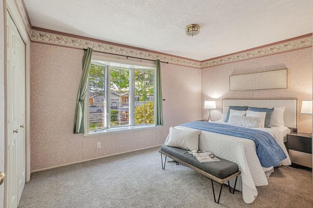 a bedroom with a bed and a window