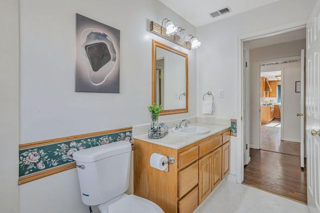 a bathroom with a toilet a sink and a mirror