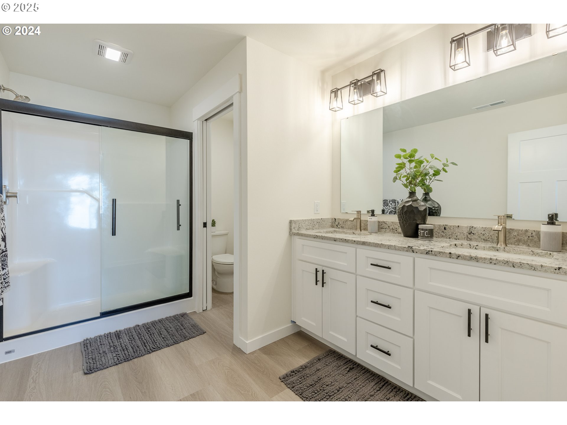 741 Periander Way Harrisburg, OR 97446 - Photo 15 of 24 a bathroom with a granite countertop sink a mirror and a shower