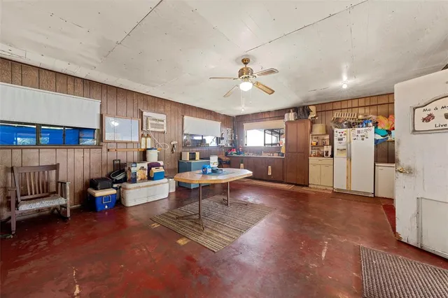 a living room with furniture and a kitchen view