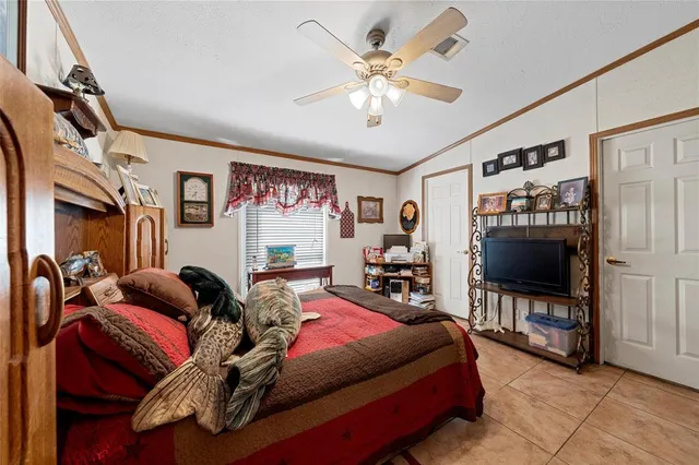a living room with furniture a flat screen tv and gym equipment