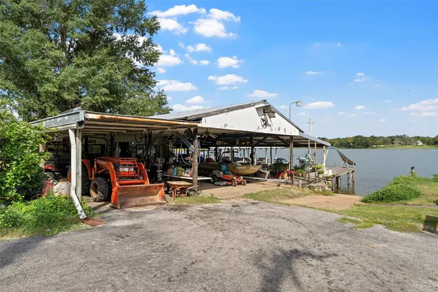a view of a wooden deck with chairs and plants