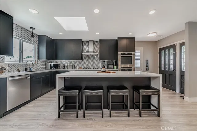 a kitchen with a sink cabinets and stainless steel appliances
