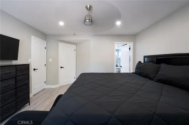 a bedroom with a bed and a flat screen tv