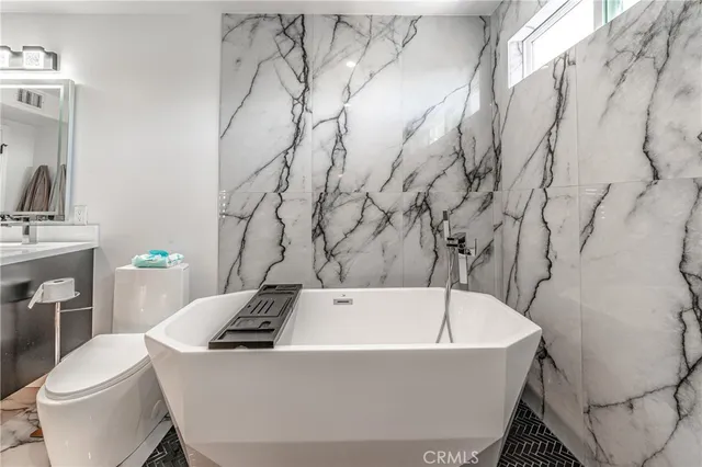 a bathroom with a bathtub and sink