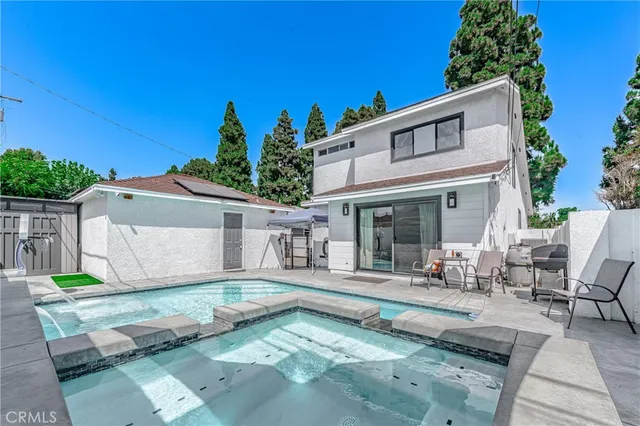 a view of a house with backyard sitting area and garden