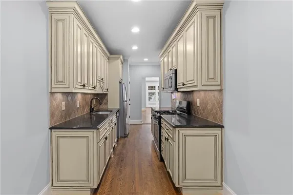 a kitchen with cabinets wooden floor and a fireplace