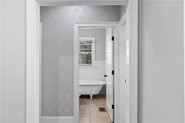 a bathroom with a granite countertop toilet sink and mirror