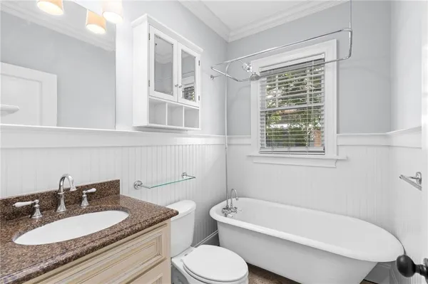 a bathroom with a granite countertop tub a sink and a window