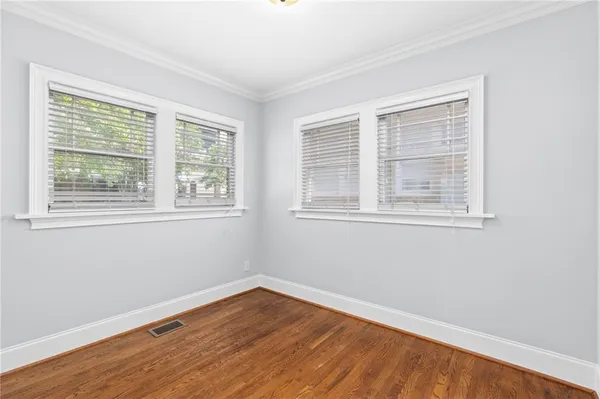 wooden floor in an empty room with a window