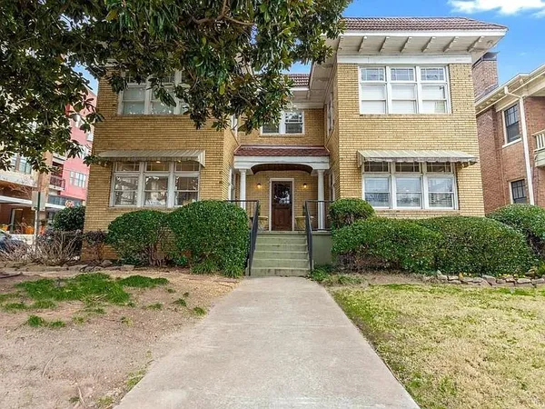 a view of a house with more windows and flower plants