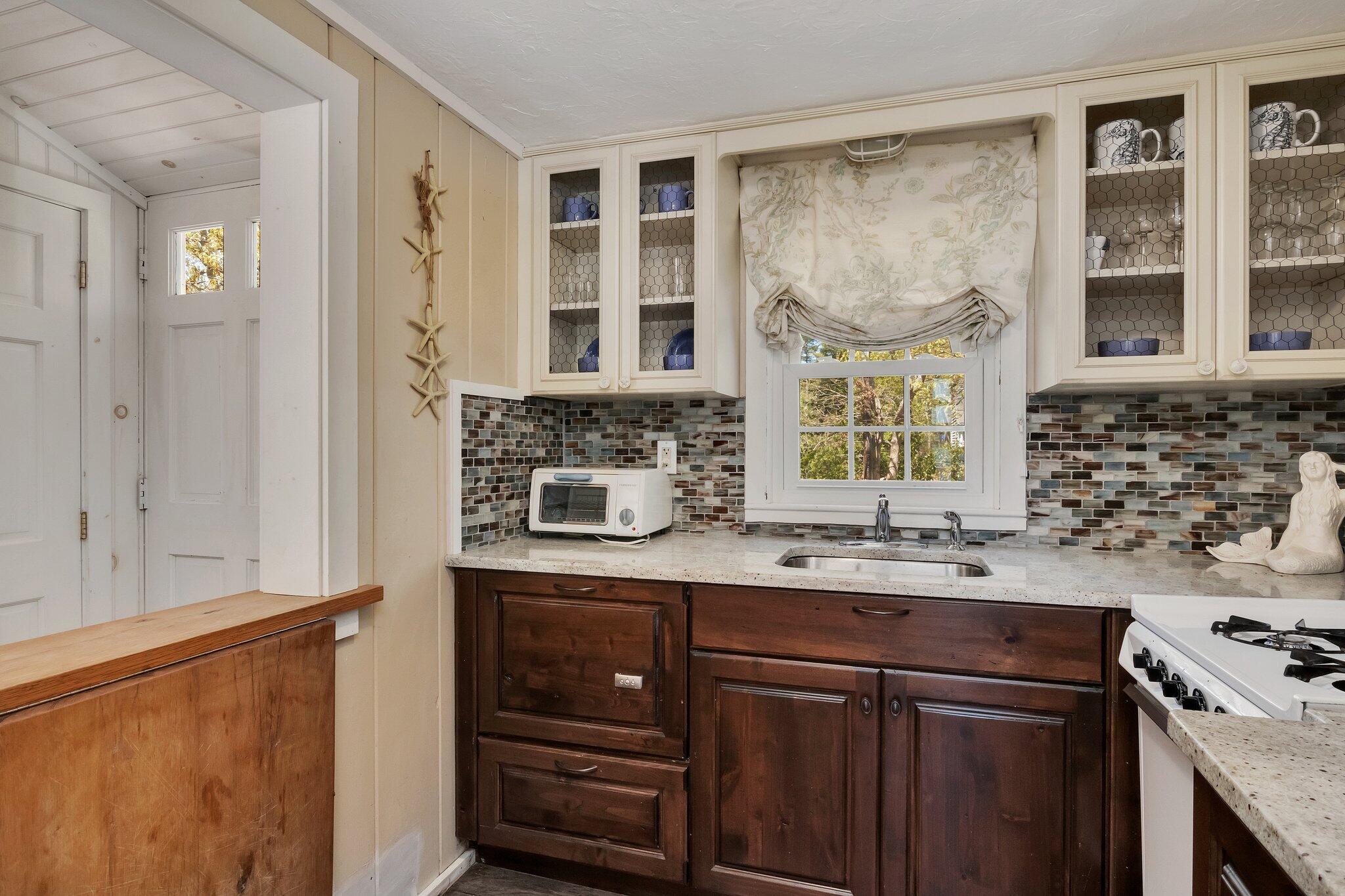 28 Swan Lake Road West Yarmouth, MA 02673 - Photo 11 of 44 a kitchen with stainless steel appliances granite countertop a sink and a stove next to a window