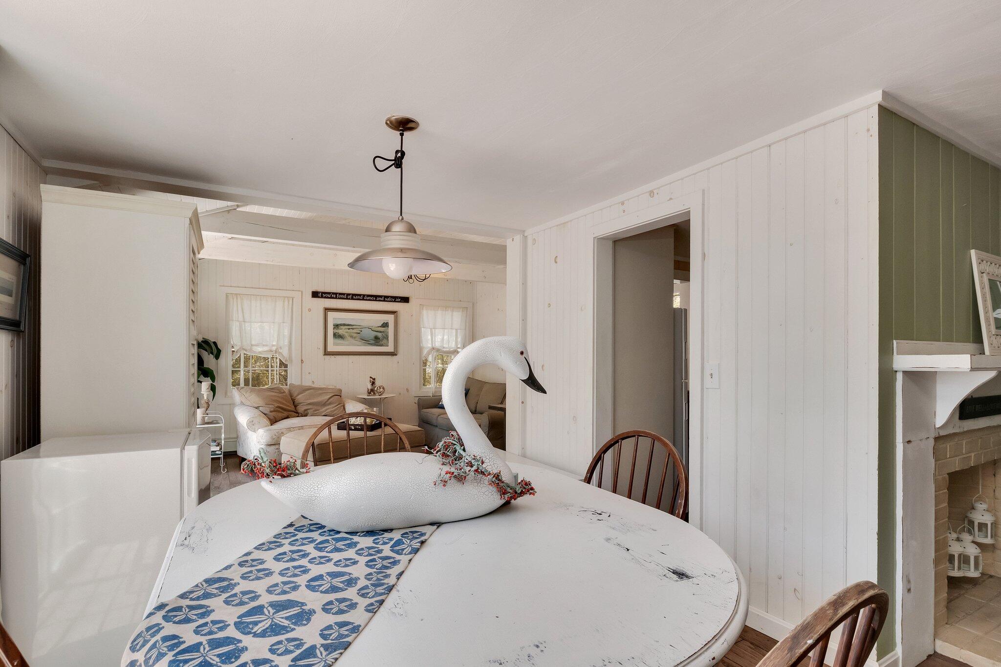 28 Swan Lake Road West Yarmouth, MA 02673 - Photo 16 of 44 a bedroom with a bed a chandelier and dresser