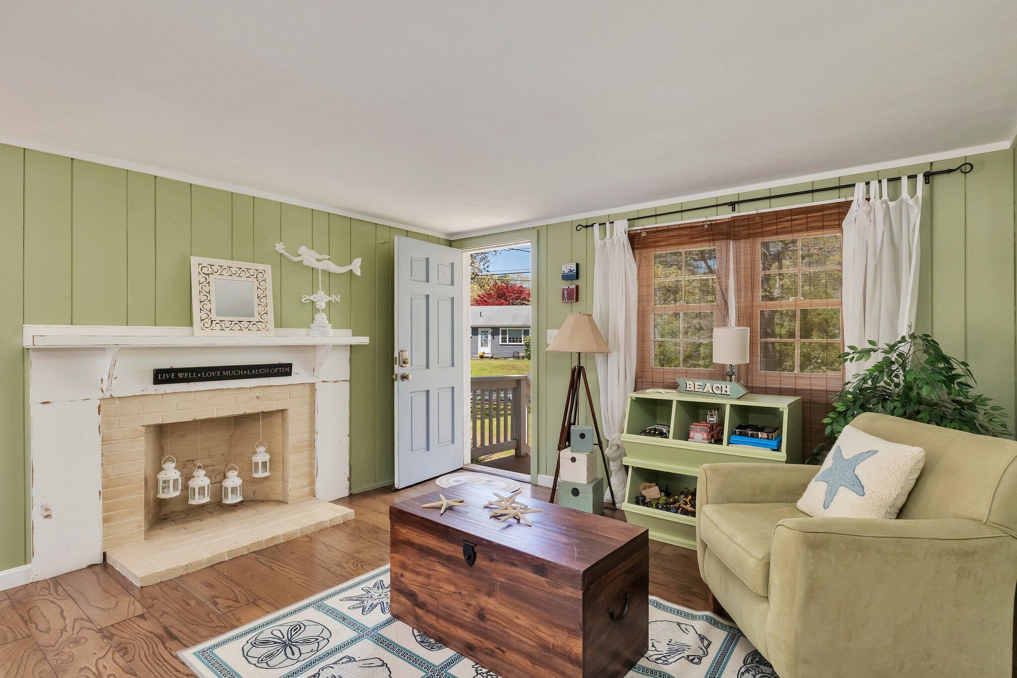 28 Swan Lake Road West Yarmouth, MA 02673 - Photo 18 of 44 a living room with furniture and a fireplace