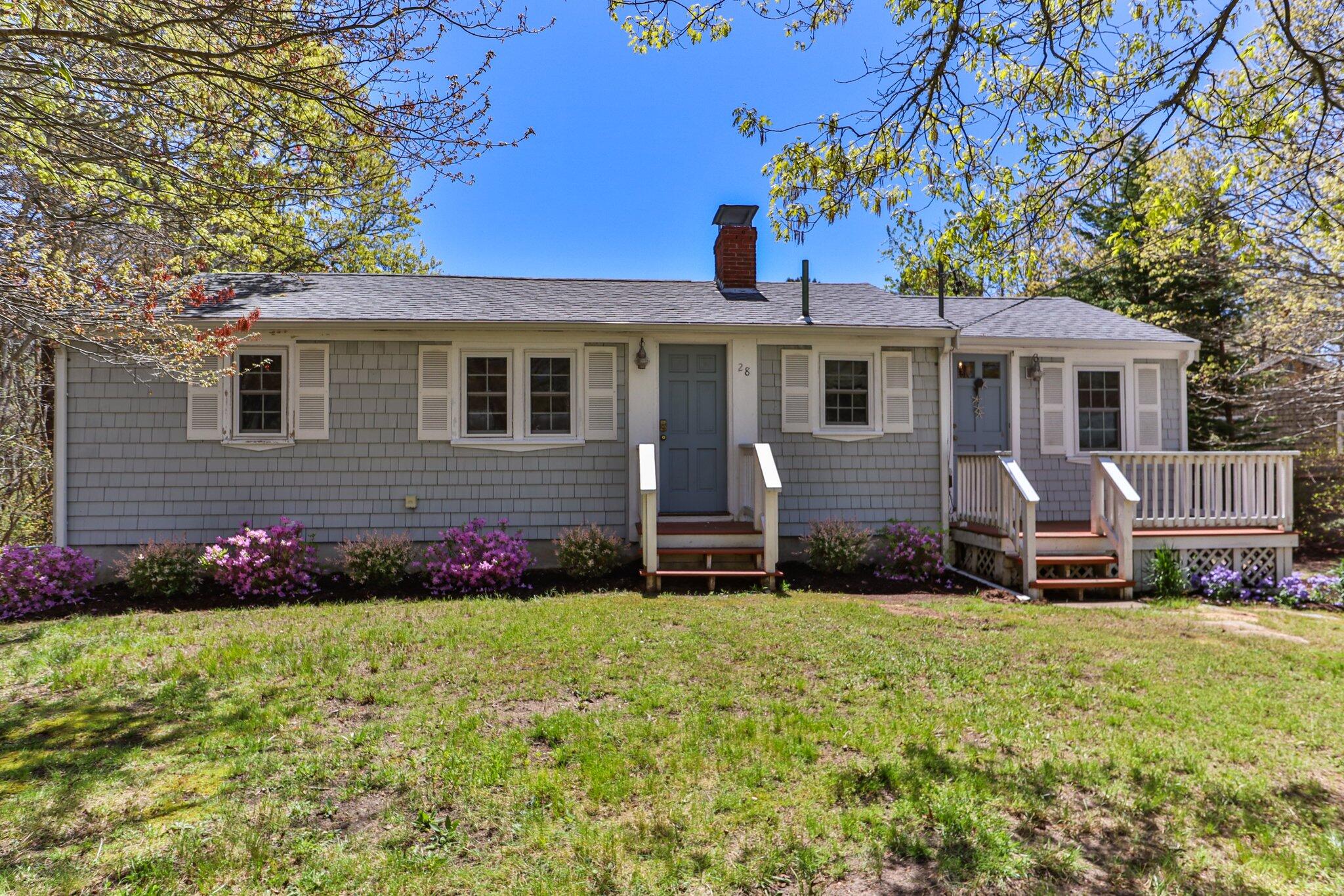 28 Swan Lake Road West Yarmouth, MA 02673 - Photo 2 of 44 a front view of a house with a garden