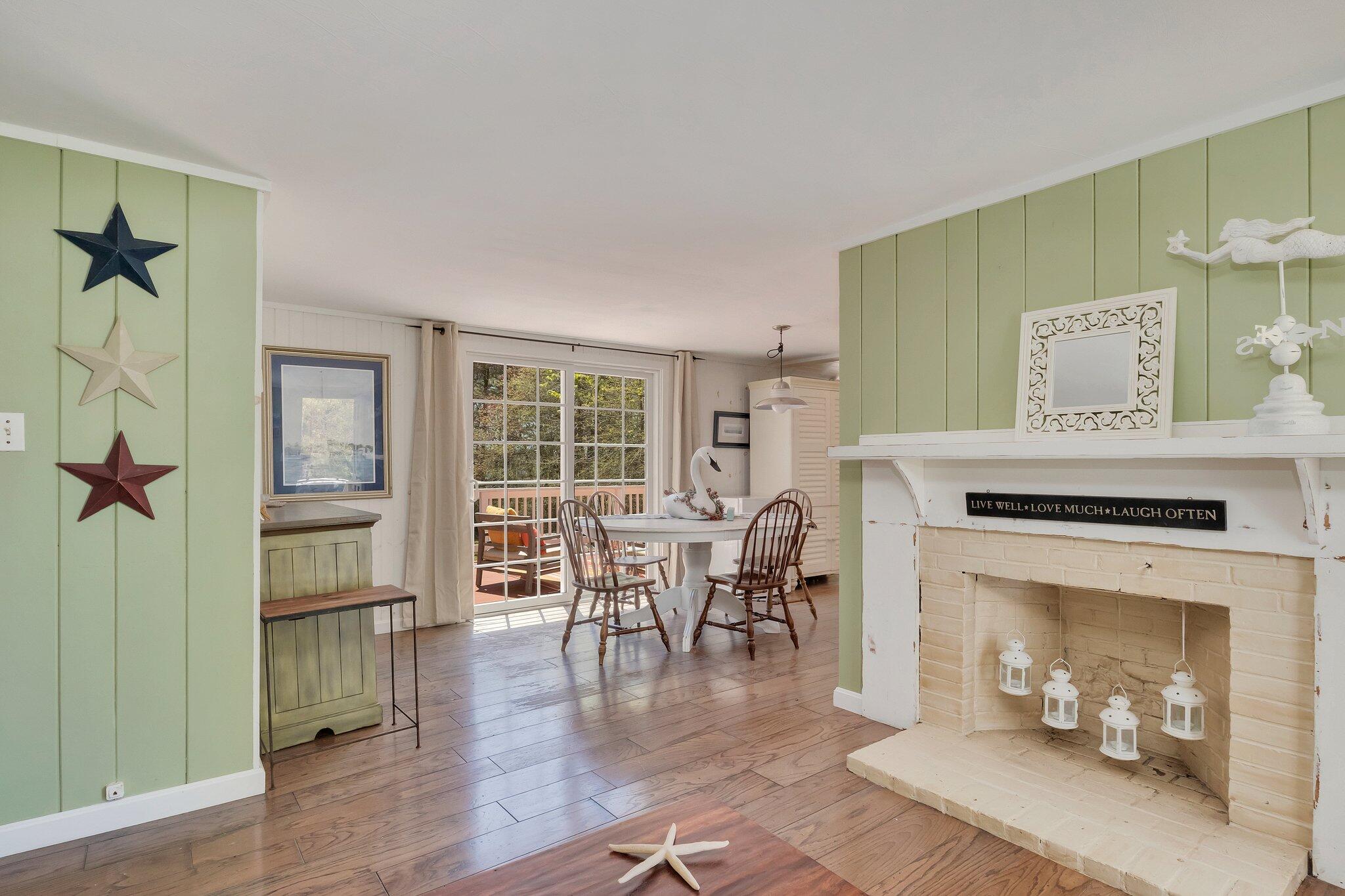 28 Swan Lake Road West Yarmouth, MA 02673 - Photo 22 of 44 a living room with furniture a fireplace and a table