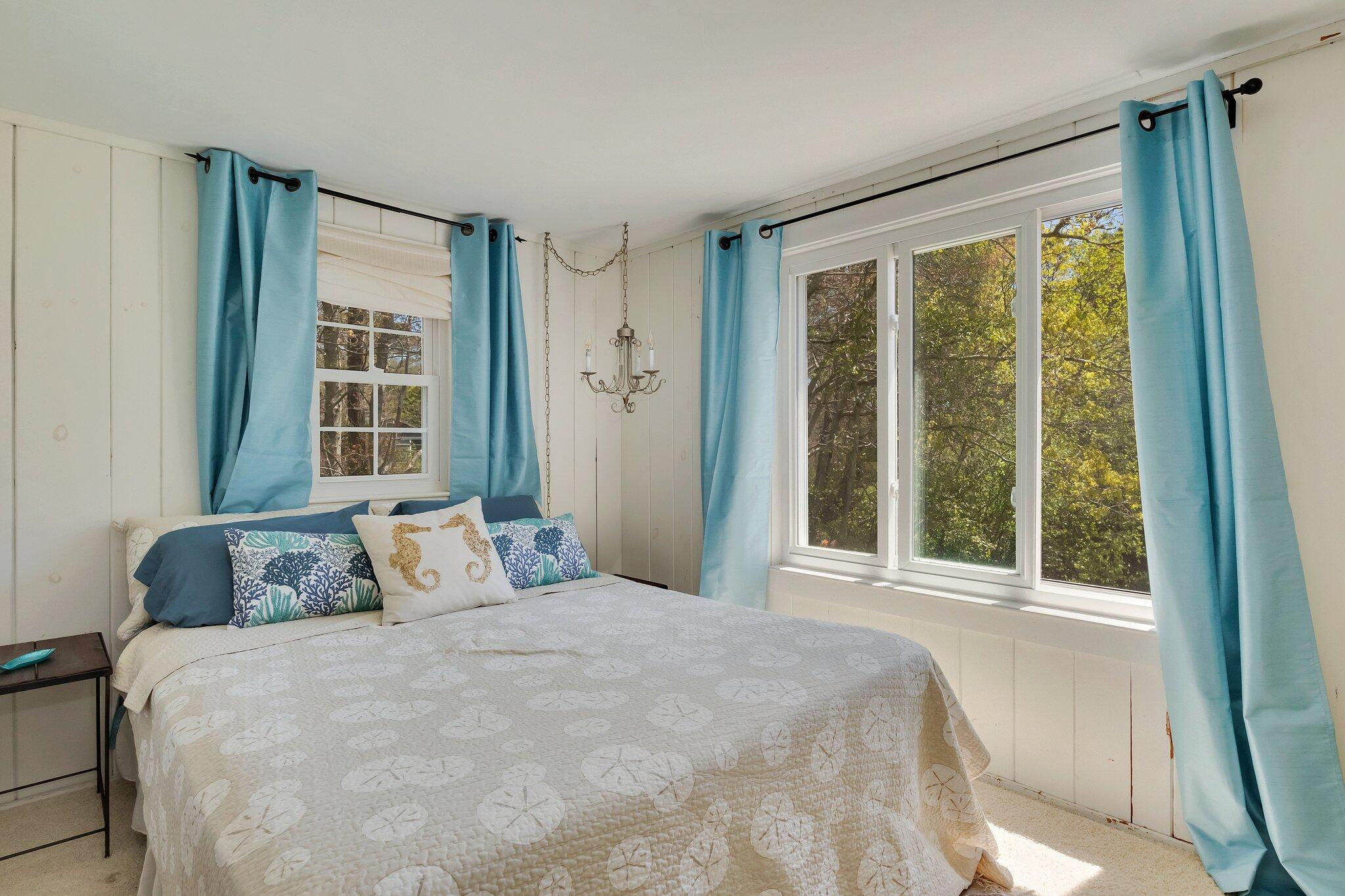 28 Swan Lake Road West Yarmouth, MA 02673 - Photo 23 of 44 a bedroom with a large bed and a large window