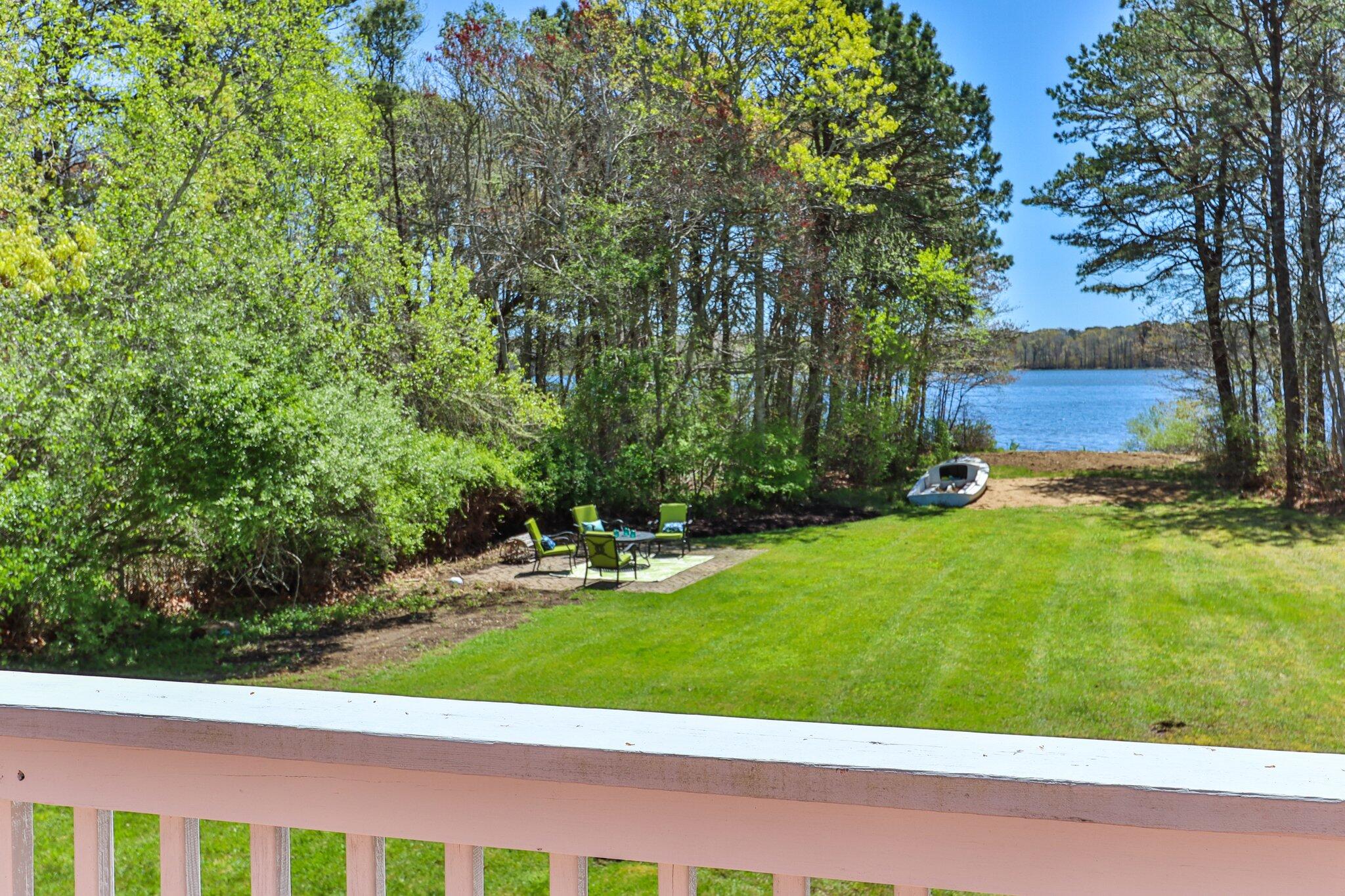 28 Swan Lake Road West Yarmouth, MA 02673 - Photo 27 of 44 a view of a backyard with potted plants and large trees
