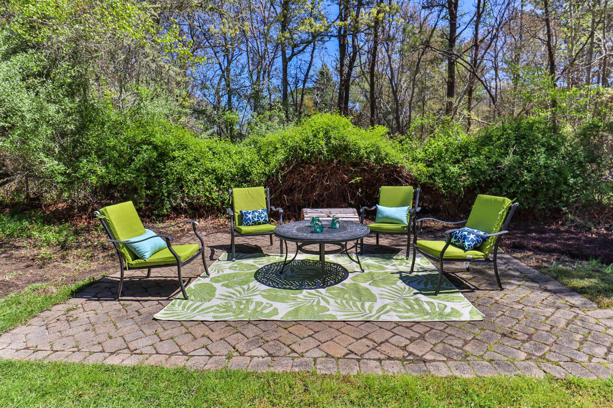 28 Swan Lake Road West Yarmouth, MA 02673 - Photo 34 of 44 a view of a chairs and table in backyard