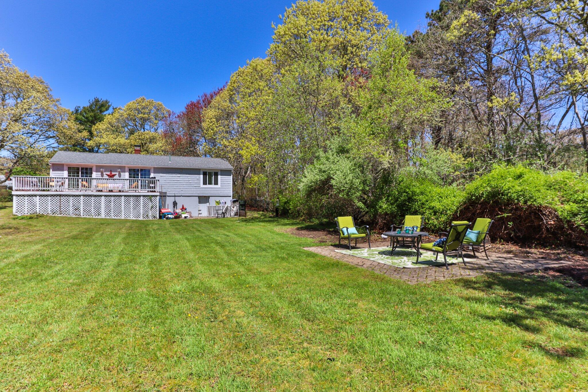 28 Swan Lake Road West Yarmouth, MA 02673 - Photo 38 of 44 a view of a house with garden and sitting area