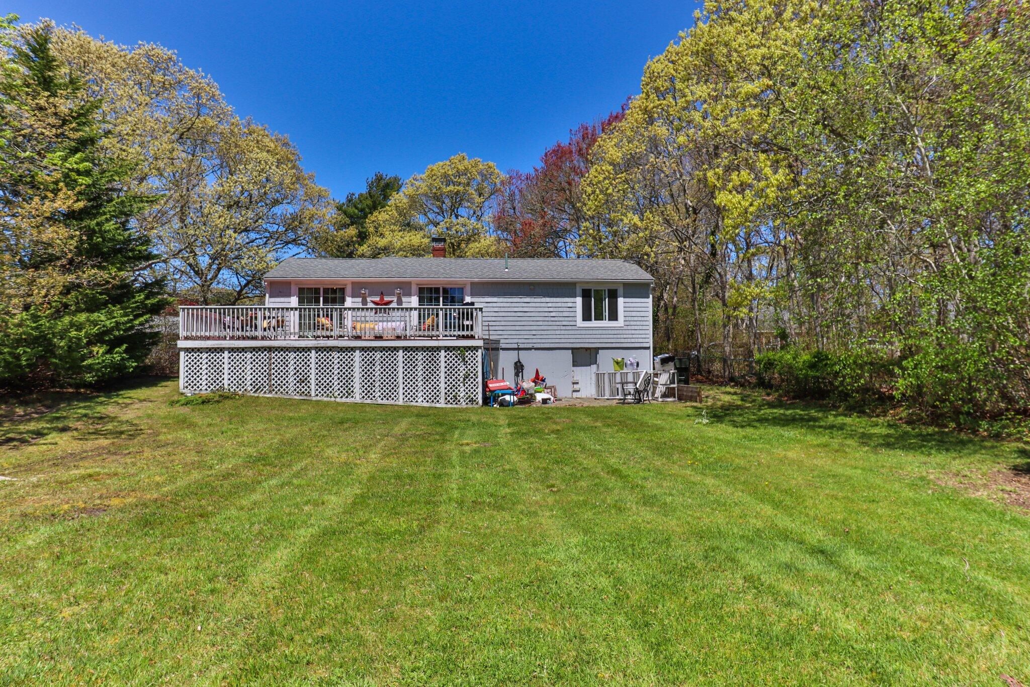 28 Swan Lake Road West Yarmouth, MA 02673 - Photo 39 of 44 a backyard of a house with lots of green space