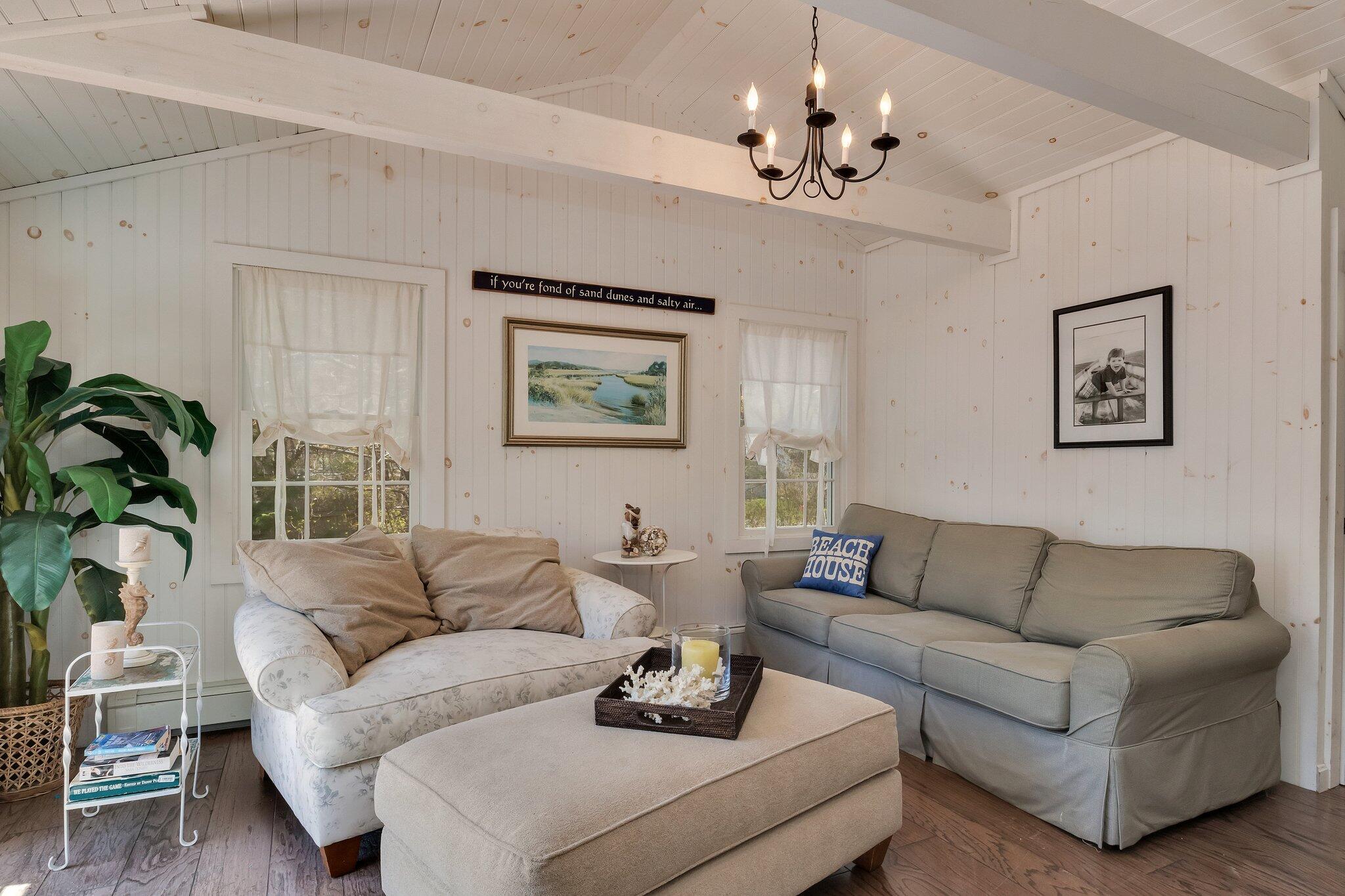 28 Swan Lake Road West Yarmouth, MA 02673 - Photo 6 of 44 a living room with furniture and a chandelier