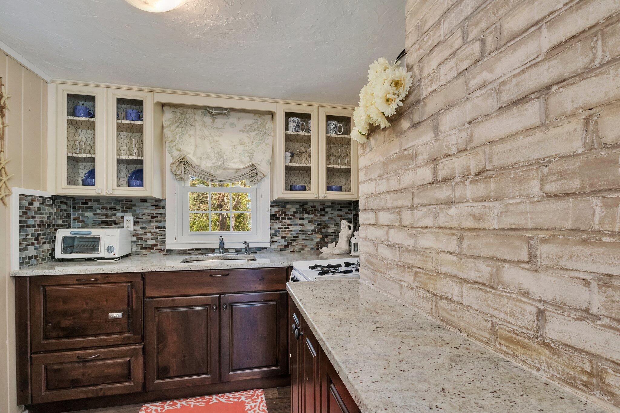 28 Swan Lake Road West Yarmouth, MA 02673 - Photo 10 of 44 a bathroom with a granite countertop sink a toilet and shower