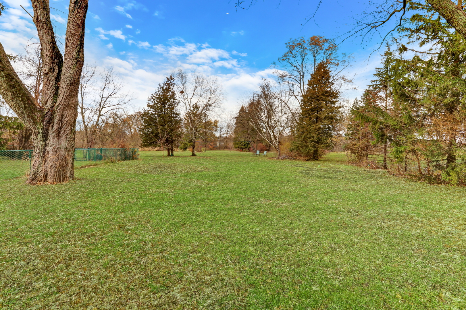 358 Rye Road Mundelein, IL 60060 - Photo 30 of 38 a view of a green field with trees in the background