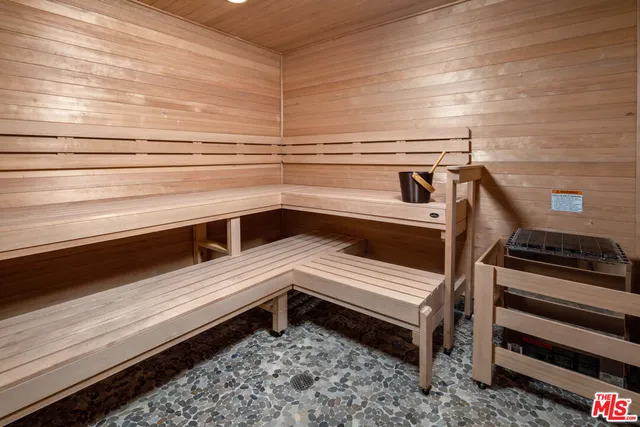 a living room with furniture and large windows