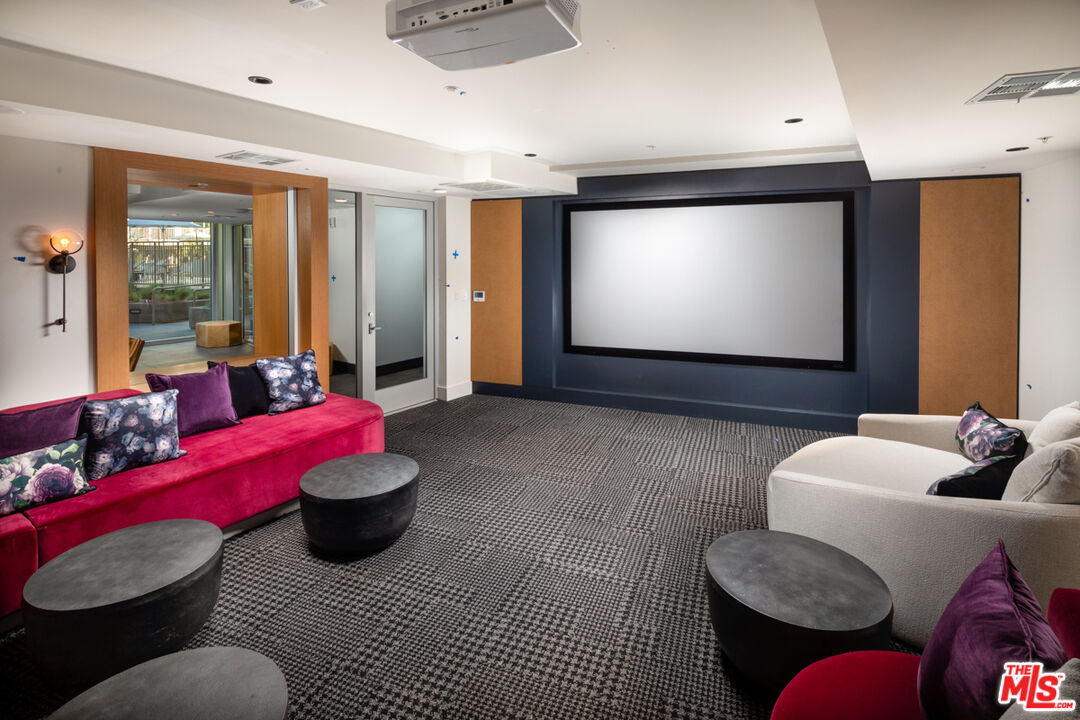 750 South Oxford Avenue, Unit 726 Los Angeles, CA 90005 - Photo 29 of 29 a living room with furniture and a flat screen tv