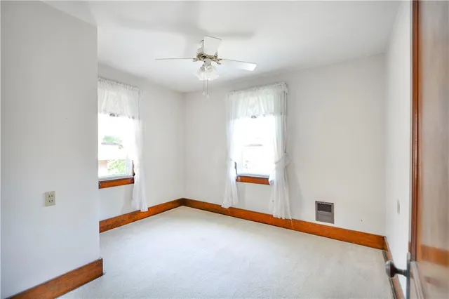a view of a livingroom with a ceiling fan and window