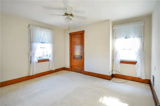 an empty room with windows and closet