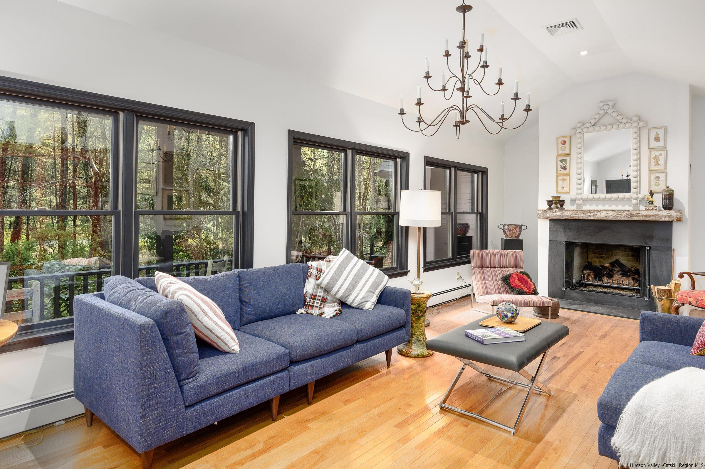 279 Scarawan Road Stone Ridge, NY 12484 - Photo 8 of 23 a living room with furniture large window and a fireplace
