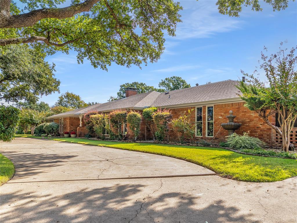 4446 Thunder Road Dallas, TX 75244 - Photo 2 of 39 Single story home with a front lawn, a chimney, brick siding, and curved driveway