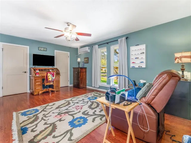 a bedroom with furniture and a flat screen tv