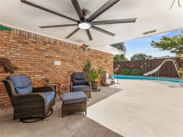 a view of a patio with a table and chairs