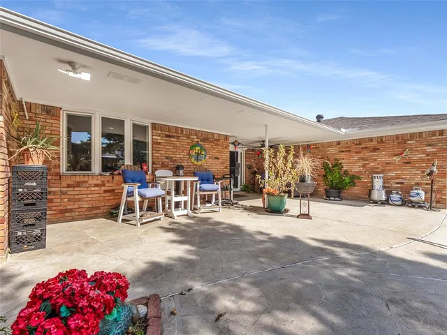 a view of a patio with table and chairs and potted plants