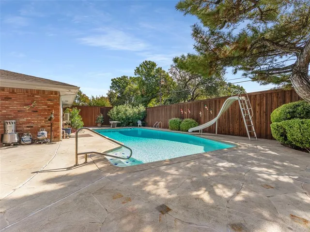 a view of backyard with a slide