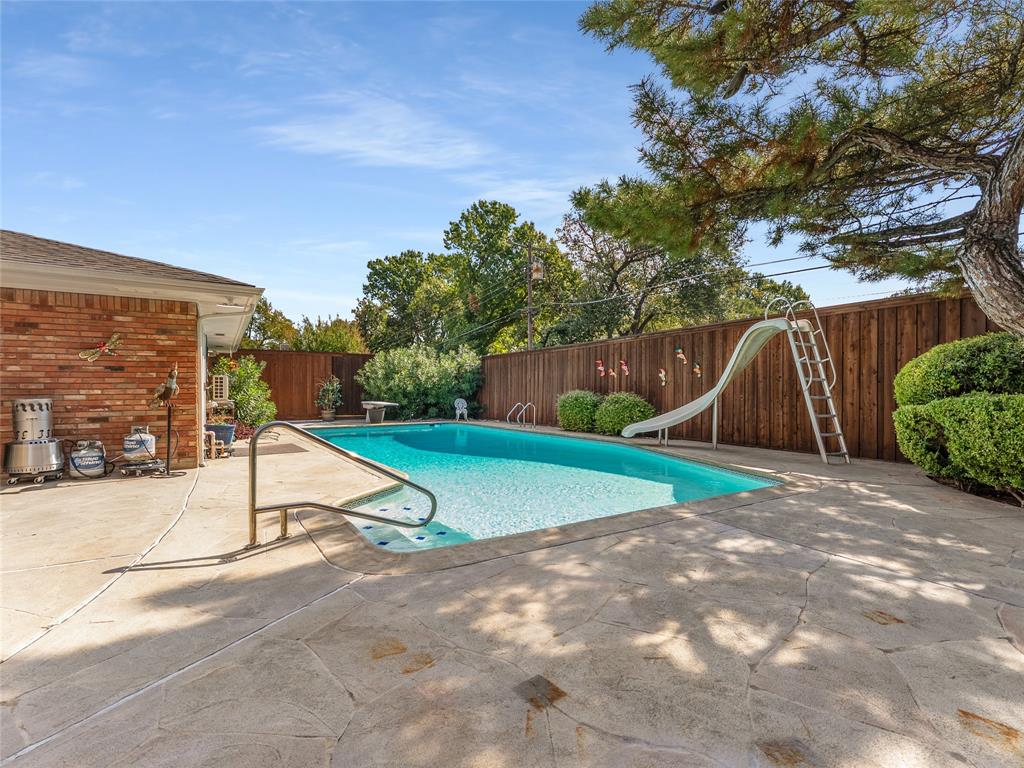 4446 Thunder Road Dallas, TX 75244 - Photo 34 of 39 View of pool featuring a fenced backyard, a patio area, and a water slide