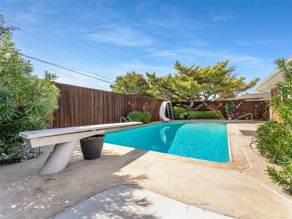 4446 Thunder Road Dallas, TX 75244 - Photo 35 of 39 View of pool featuring a water slide, a fenced backyard, and a patio