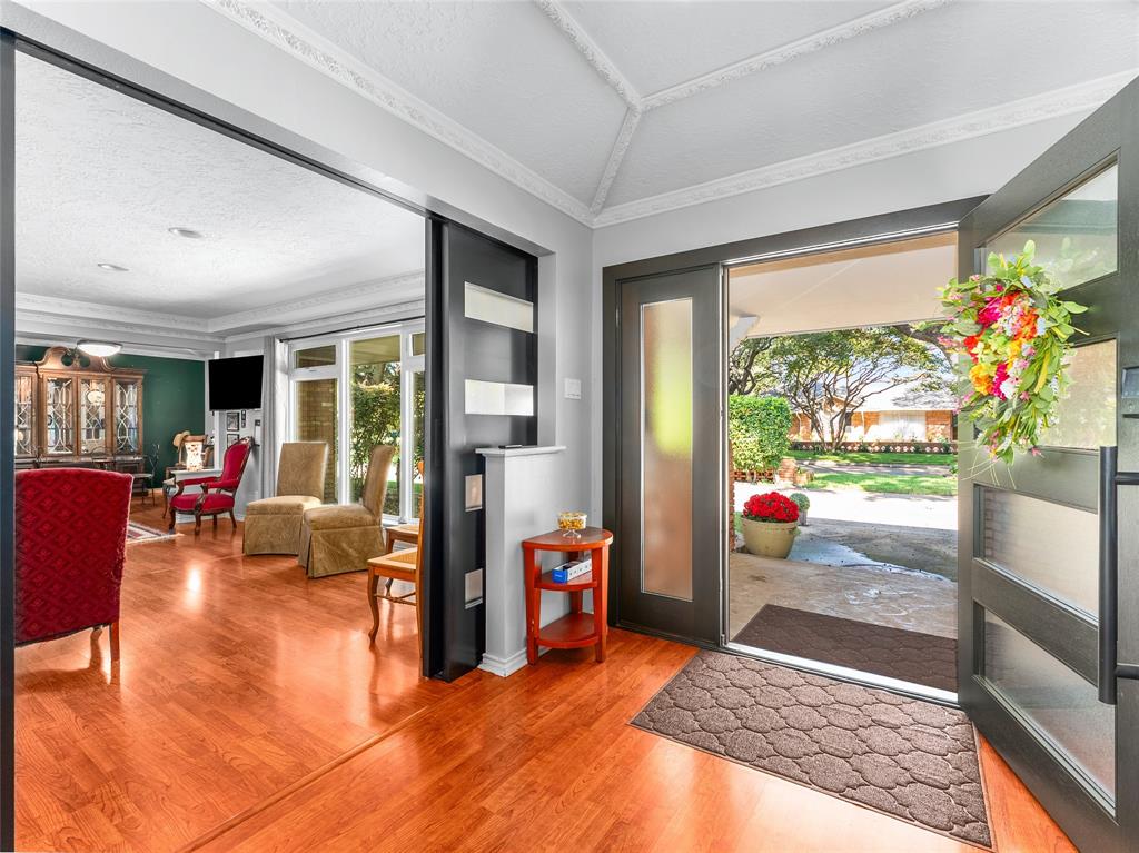 4446 Thunder Road Dallas, TX 75244 - Photo 6 of 39 Foyer entrance featuring light wood finished floors, crown molding, healthy amount of natural light, a textured ceiling, and vaulted ceiling