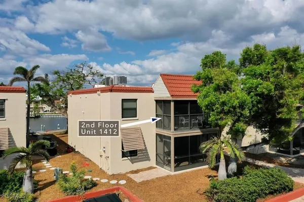 an aerial view of a house with swimming pool and sitting space