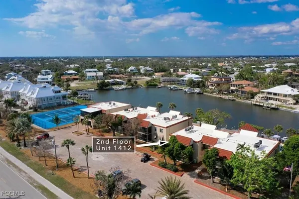an aerial view of a city with lots of residential buildings lake and ocean view