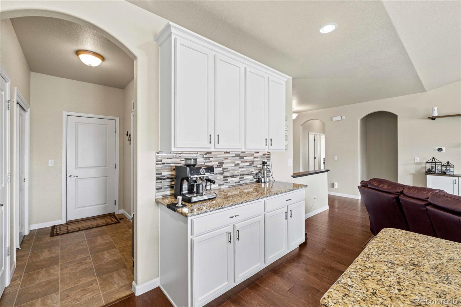 1030 Wagon Train Drive Milliken, CO 80543 - Photo 14 of 49 a kitchen with stainless steel appliances kitchen island granite countertop a sink and cabinets