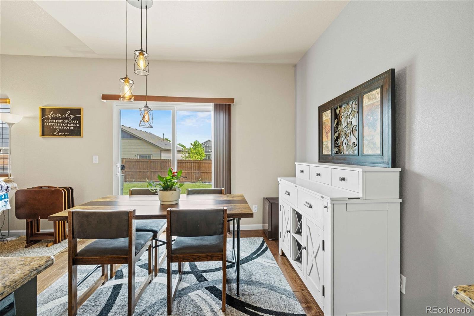 1030 Wagon Train Drive Milliken, CO 80543 - Photo 16 of 49 a dining room with furniture and window
